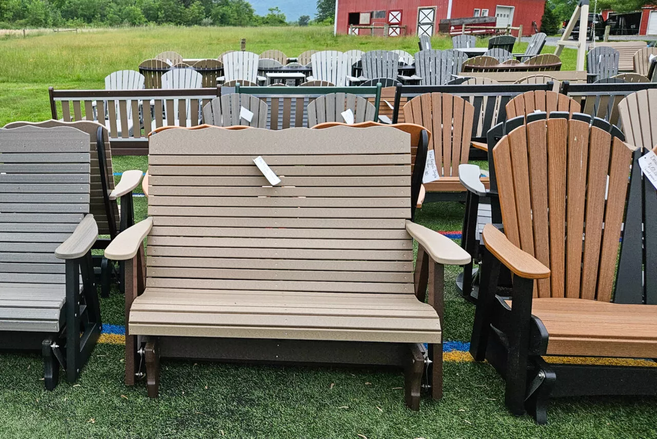 Poly benches in front of a red barn