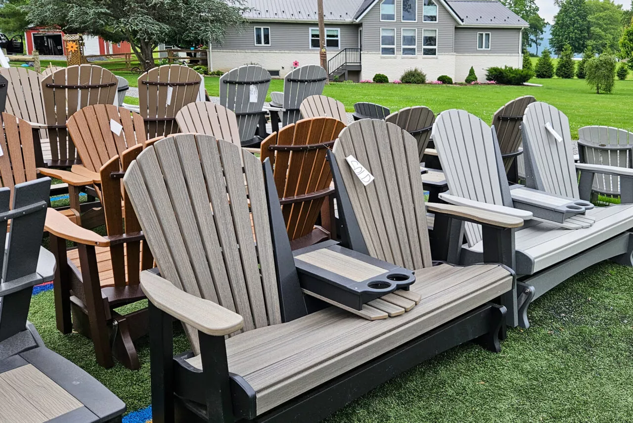 Poly glider bench on the lawn with a house behind it